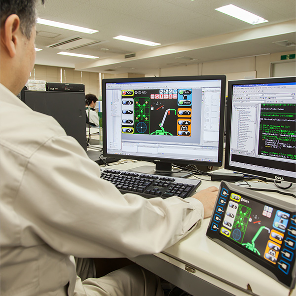 MAEDA engineer looking at CAD drawings on monitors