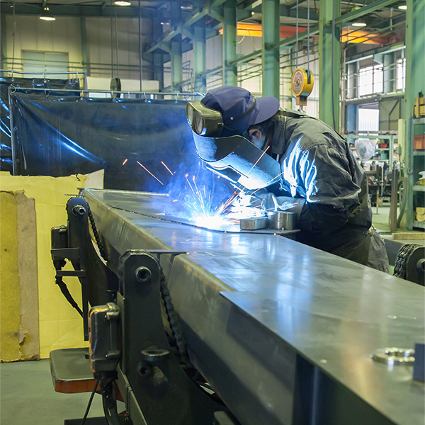 Maeda factory showing team member welding boom